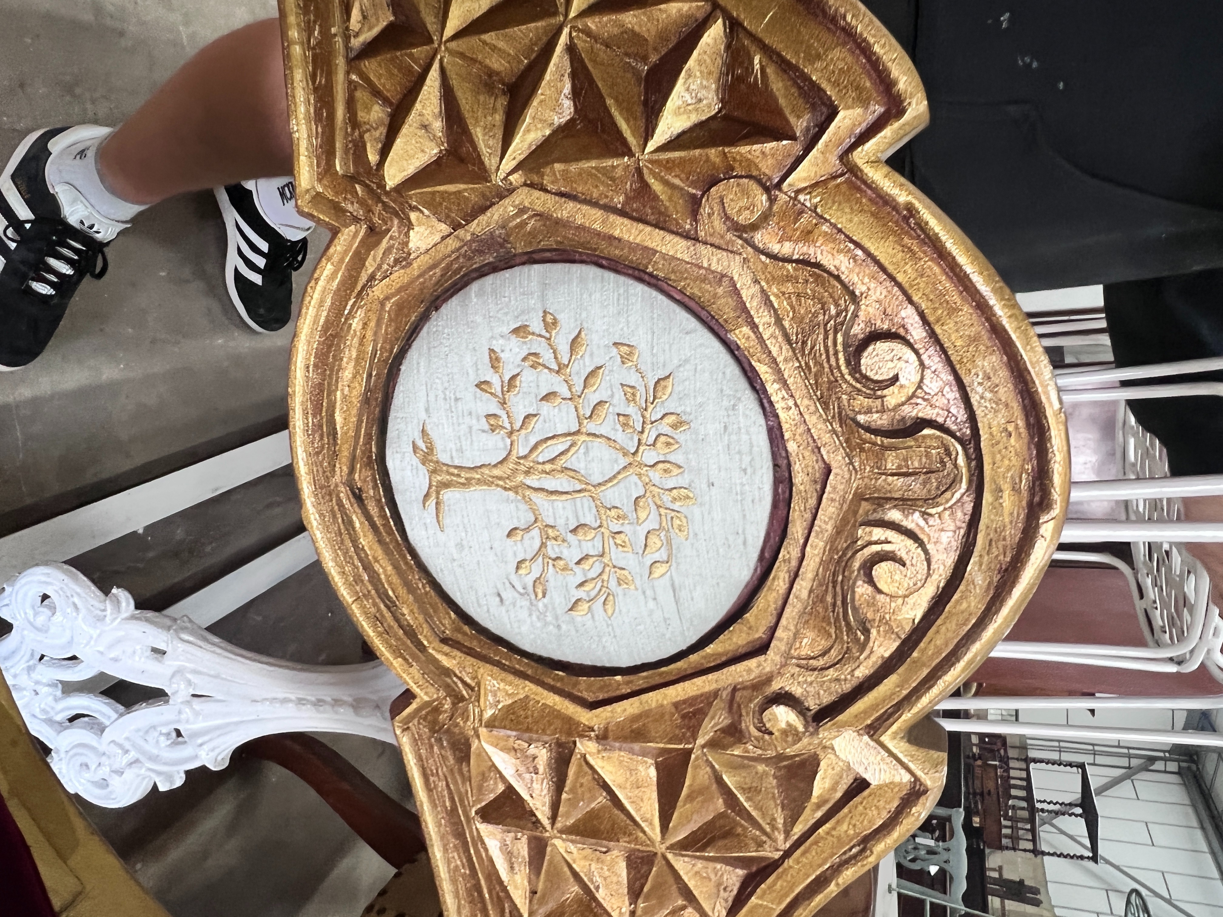 A pair of Renaissance style giltwood and composition X frame elbow chairs, on lion's paw feet, width 73cm, depth 59cm, height 99cm